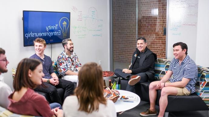 Students speaking with Daniel Lubetzky in the Center for Innovation and Entrepreneurship